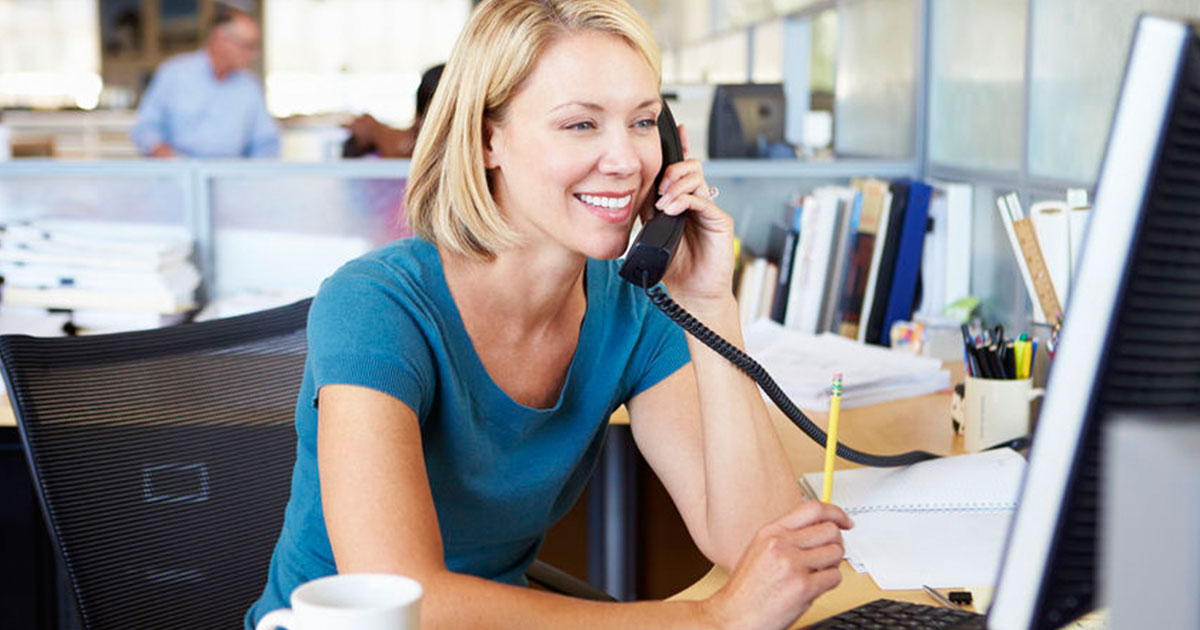 Lady smiling while selling insurance over the phone